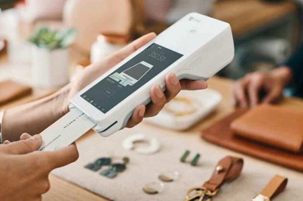 Customer paying by card on a Clover Flex at a boutique counter