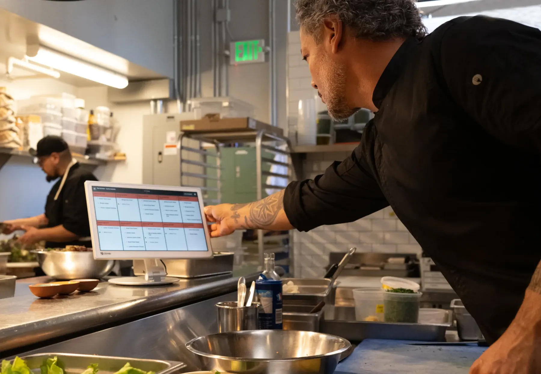 Chef checking orders on a Clover Kitchen Display