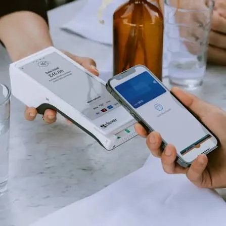 Customer paying by phone on a Clover terminal