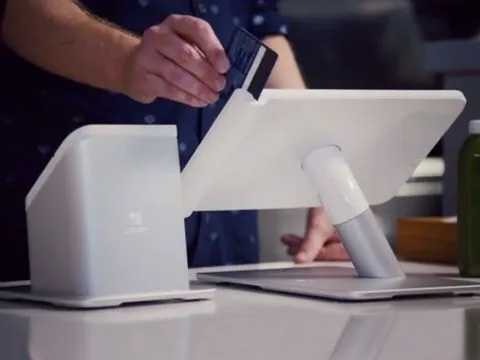 Countertop point-of-sale terminal accepting a card at a retail counter